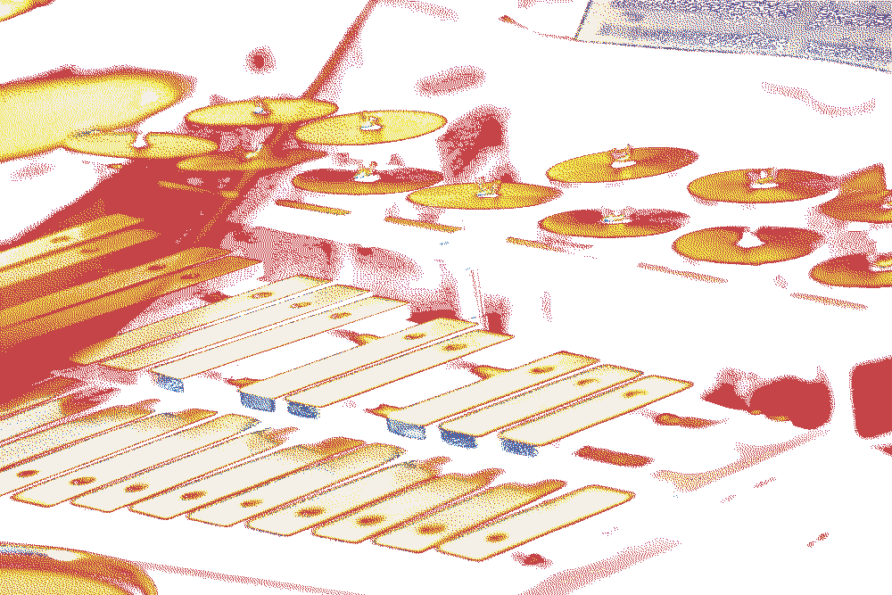 Stock image of hands playing crotales and a glockenspiel.