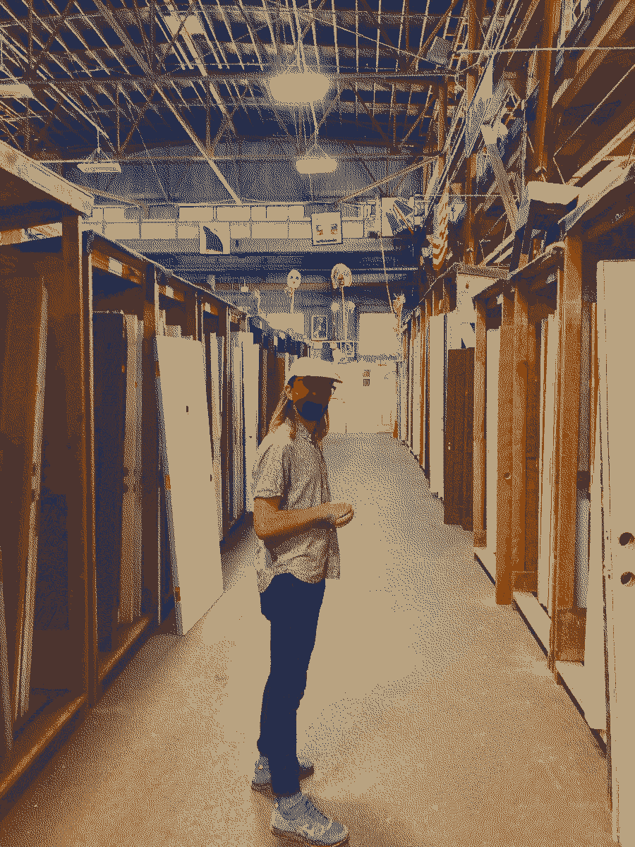 A friend standing amongst hundreds of antique doors for sale.